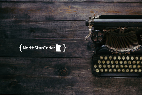 A typewriter on a table with the word NorthStarCode and a symbol of the state of Minnesota next to it
